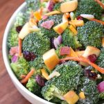 Broccoli, cranberries, carrots, apples, and cheese come together to make an amazing salad with delicious flavors and textures. The honey yogurt dressing on top makes this salad absolutely incredible! A delicious clean version of your favorite Broccoli Salad!