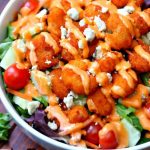 A delicious salad full of fresh vegetables and topped with buffalo shrimp. If you love all buffalo shrimp, you're going to love this Buffalo Shrimp Salad!