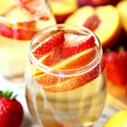 Peach Champagne Punch made with peach schnapps, champagne, and fresh peaches.