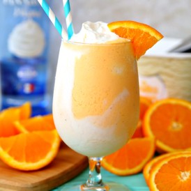 Boozy Orange Creamsicle Float recipe with orange soda, whipped cream vodka, and vanilla ice cream.