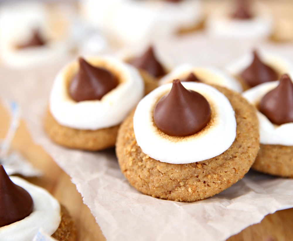 S'mores Blossom Cookies Graham Cracker Cookies with a toasted marshmallow and topped with a hershey kiss.