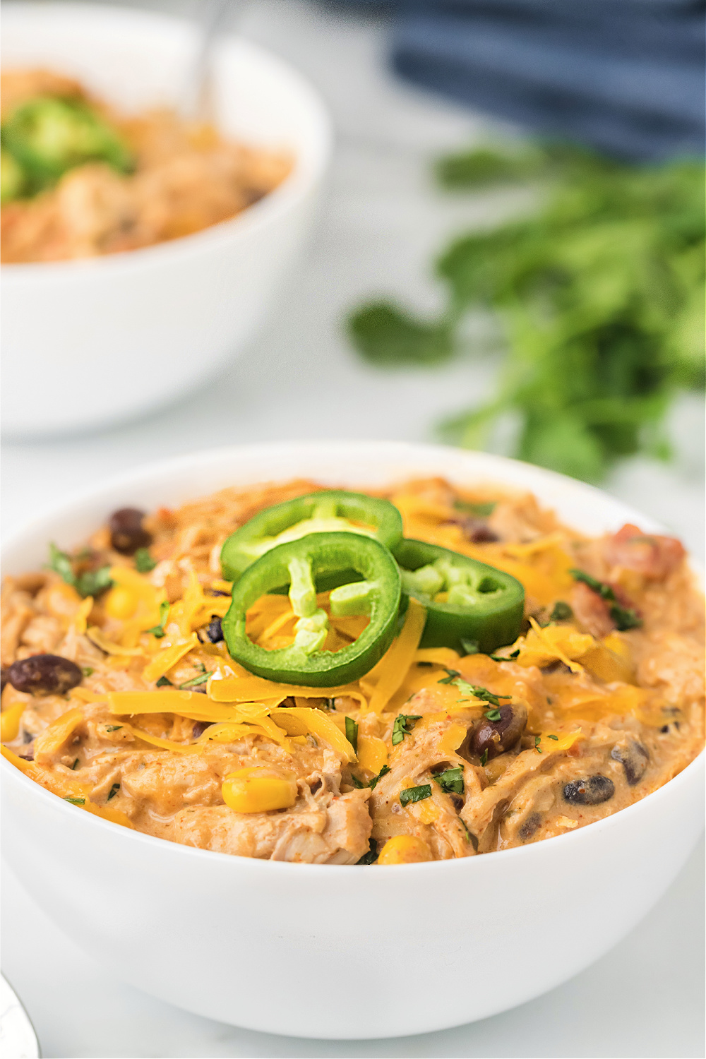 Ranch Chicken Chili in white bowl with jalapenos