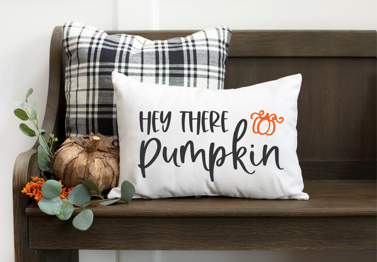 Welcome family and friends into your home with this free Hey There Pumpkin SVG.  Show on a white pillow.
