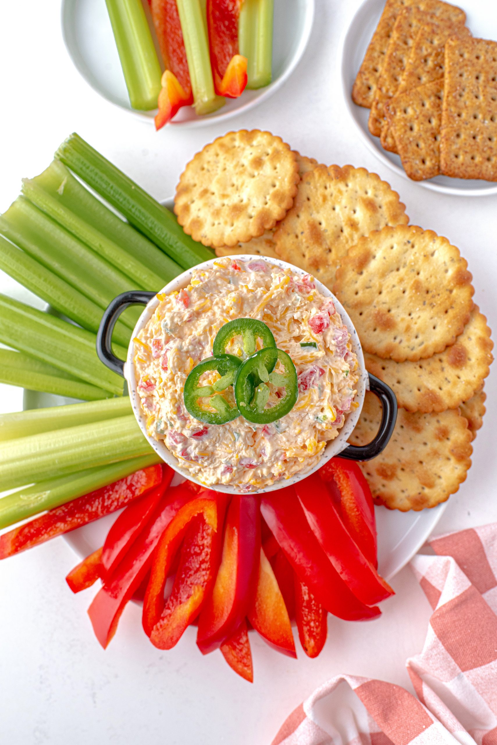 Jalapeno Pimento Cheese Dip with crackers and vegetables.
