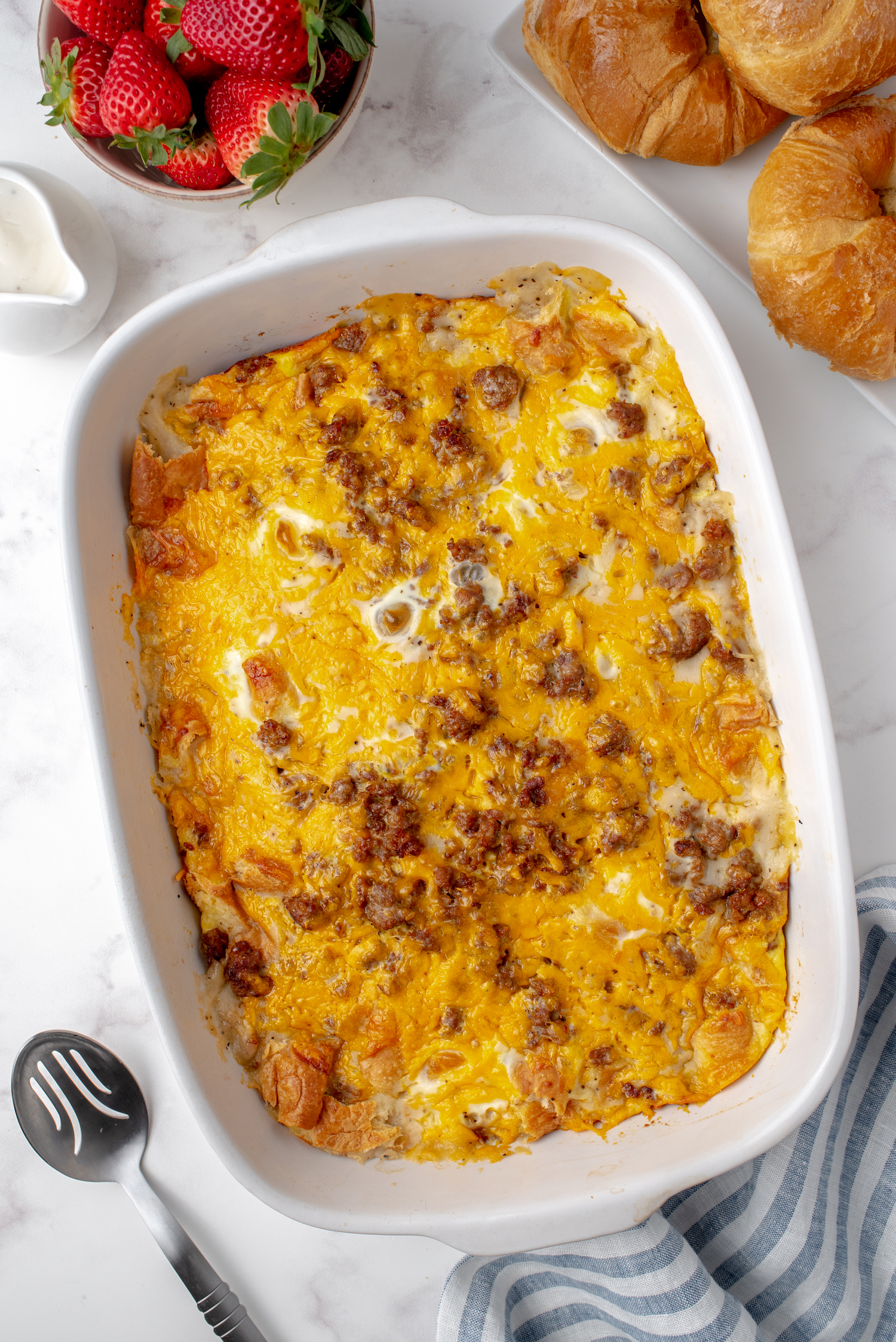 Easy breakfast casserole with sausage gravy, eggs, and croissants