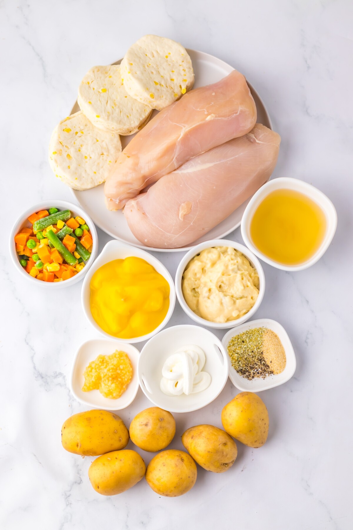 Ingredients for slow cooker chicken pot pie arranged on kitchen counter