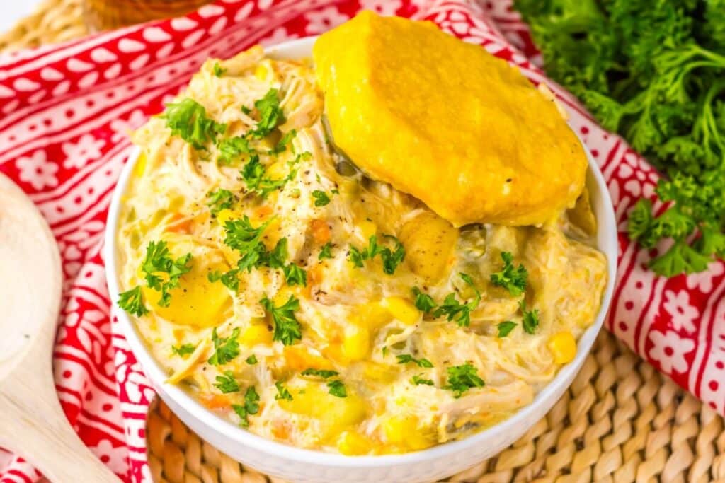 Slow cooker chicken pot pie served with biscuit on top