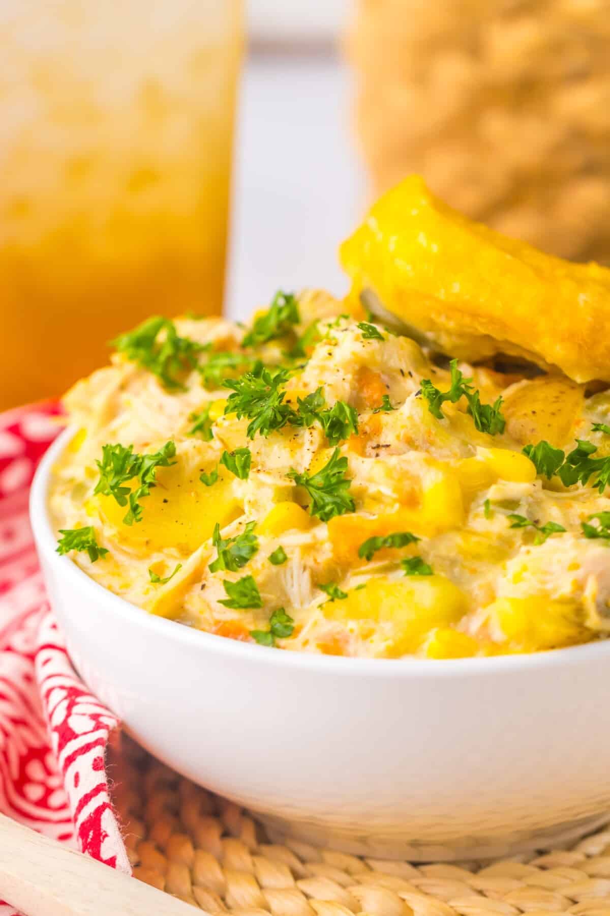 Bowl of slow cooker chicken pot pie topped with fluffy biscuit
