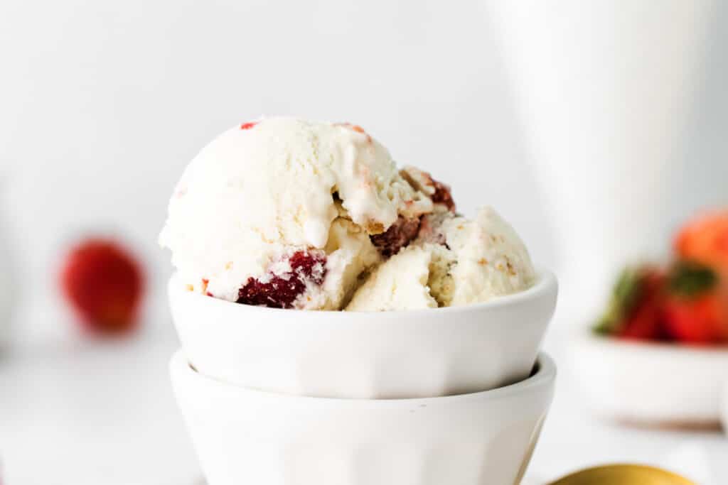 Homemade no churn strawberry cheesecake ice cream with fresh strawberry swirls