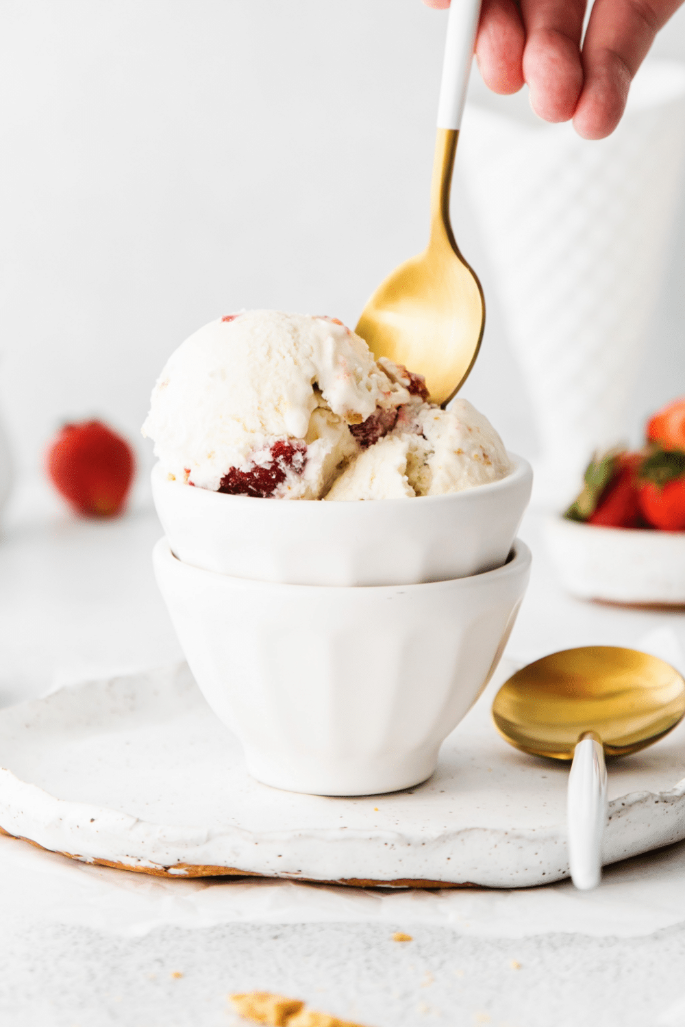 Scoop of creamy strawberry cheesecake ice cream with strawberries and graham cracker pieces