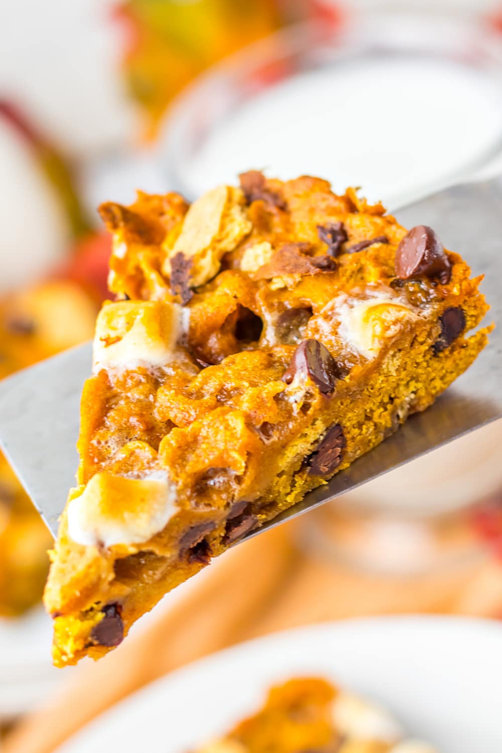Fall Pumpkin S’mores Cookie Cake ready to serve on serving spatula